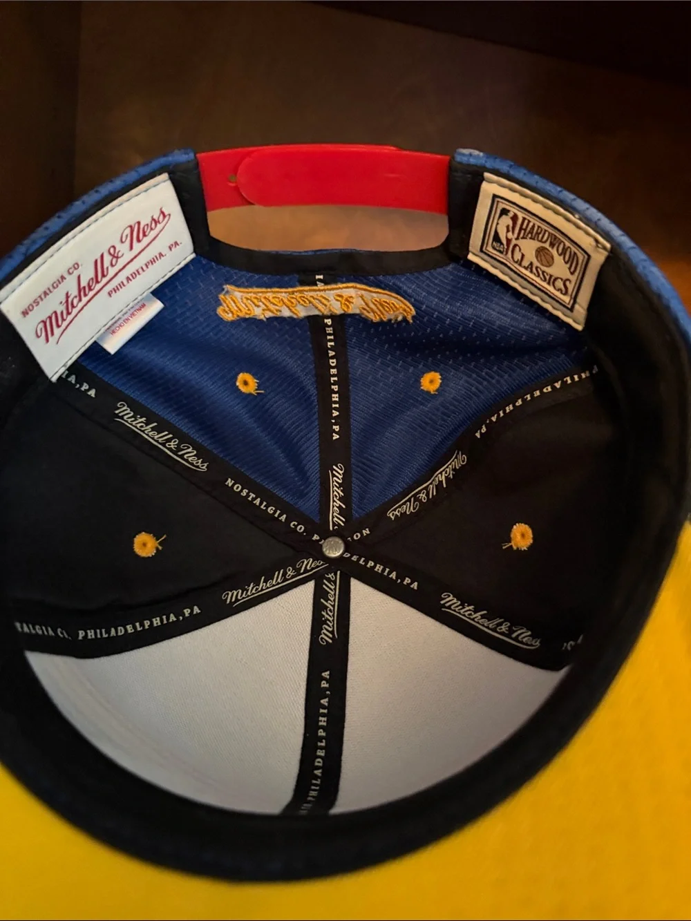 Mitchell & Ness Blue Snapback Hat with Yellow Embroidery and Red Strap